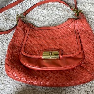 Orange coach shoulder bag.